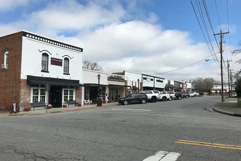 Row of white and brick storefronts on East Union Street in Marshville