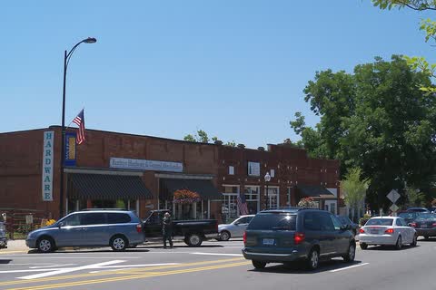 Brick storefronts and parked cars on Trade Street in downtown Matthews