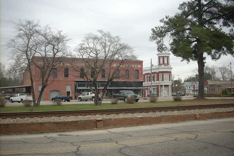 Historic brick buildings across a railroad line in downtown Maxton