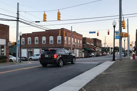 Mayodan main street intersection with a long two-story brick building and traffic lights