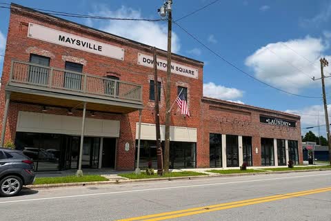 A two-story red-brick commercial building marked 'Maysville Downtown Square'