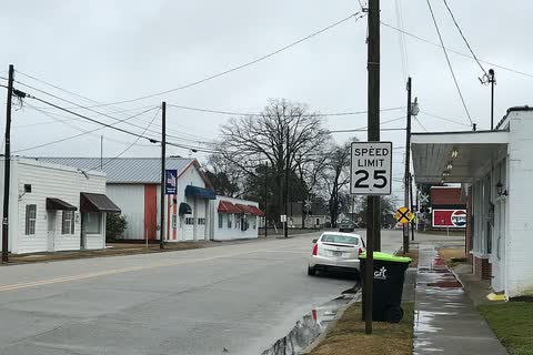 A small-town street with white commercial buildings in Micro