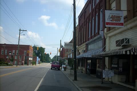 Main street in Mount Gilead with brick storefronts and striped awnings