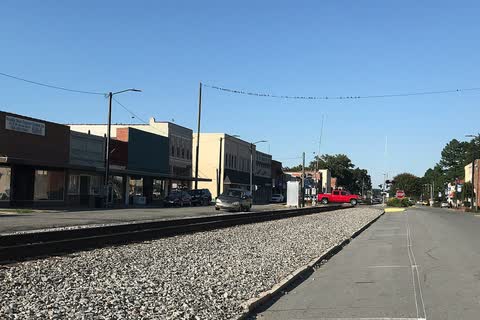 A row of storefronts facing the railroad tracks in Mount Olive
