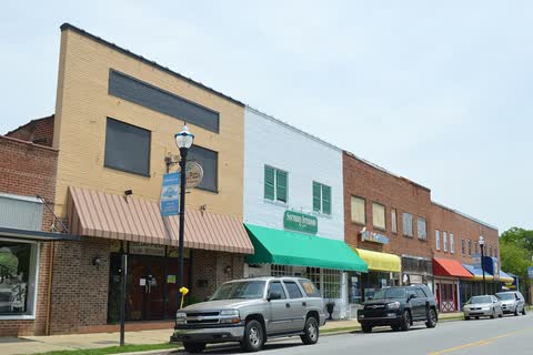 Brick commercial buildings with colorful awnings along Main Street in Murfreesboro