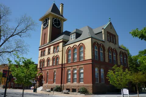 A red-brick Victorian municipal building with a clock tower in New Bern