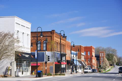 Restored brick commercial buildings and street lamps on Main Street in Newton
