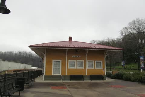 Yellow wooden railroad depot with a red roof in Old Fort
