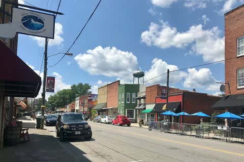 Colorful storefronts and outdoor umbrellas on West Main Street in Pilot Mountain