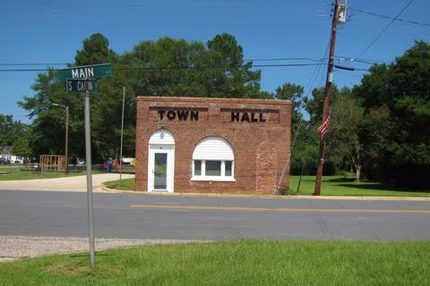 Proctorville Town Hall, a small brick building lettered TOWN HALL at a street corner