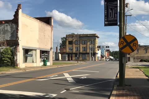 Brick commercial buildings at a railroad crossing in Robersonville