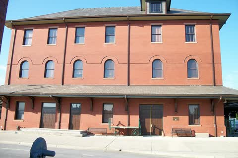 A three-story red-brick railroad station with arched windows in Rocky Mount