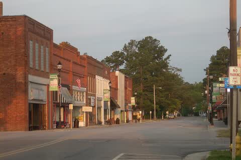 A row of red-brick storefronts along a downtown street in Roseboro