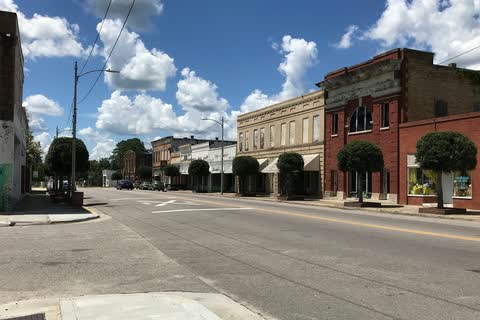 Historic brick commercial buildings and trees along West Main Street in Rowland