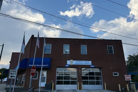 Two-story brick public safety building with flags in Sawmills
