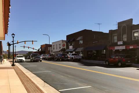 Main Street in Sparta with brick storefronts, street lamps and parked cars