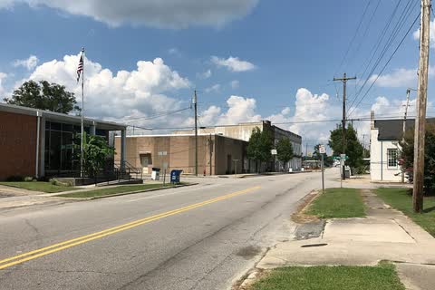 A two-lane street with the post office and other low buildings in Stantonsburg