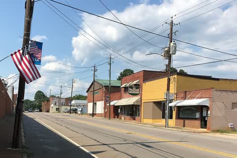 Main Street in Star with low brick and painted storefronts and an American flag