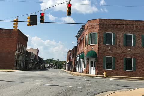 Brick buildings at a downtown Stoneville intersection with traffic lights