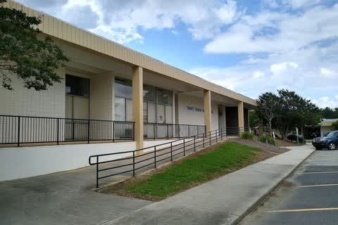 Trinity High School in Trinity, a long single-story building with a covered walkway and an access ramp