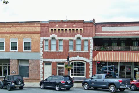 Historic brick Bank of Tryon building and neighboring storefronts in Tryon