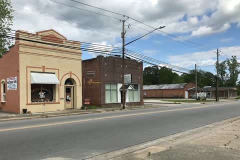 Small brick commercial buildings along a road in Vanceboro