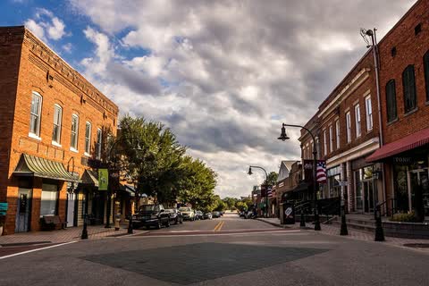 Historic brick storefronts lining a downtown street in Wake Forest