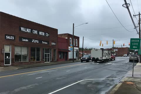 Walnut Cove street with an old motor company building and traffic lights