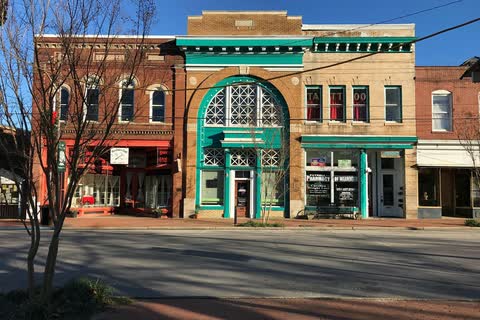 Historic brick storefronts, one with a teal decorative front, in downtown Warrenton