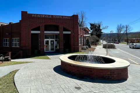 Brick Weaverville Town Hall with a round fountain plaza in front