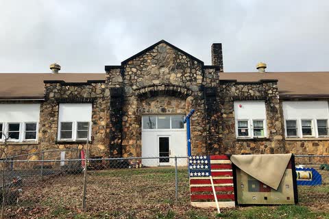 Stone Webster Rock School building with white windows